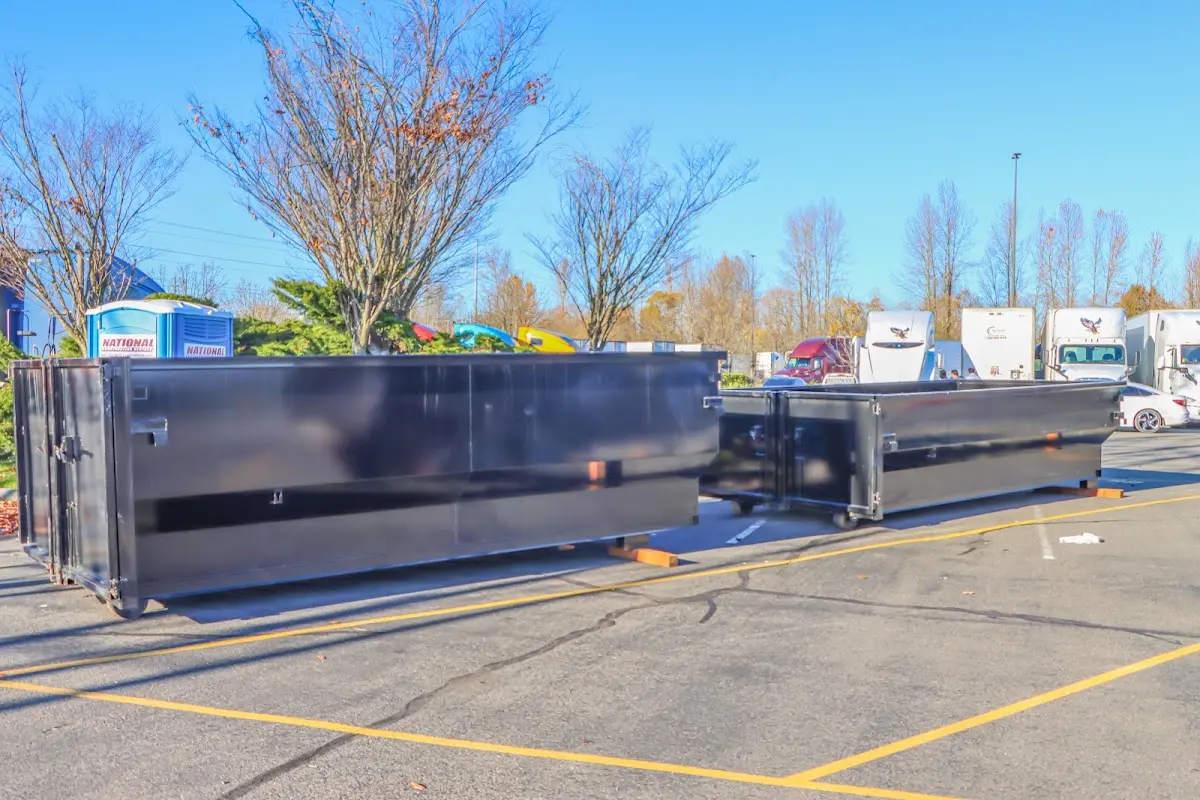 Professional dumpster rental service with roll-off container on residential driveway in Mukwonago